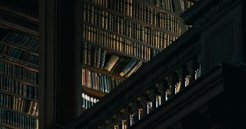Enormous staircases behind a balcony wrapped in shadow